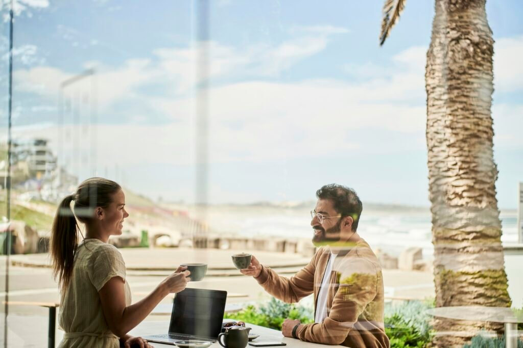 man in brown jacket sitting beside with woman at coffee shop